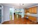 Open living room with hardwood floors, columns, fireplace and a large window overlooking a backyard at 3546 Weddington Oaks Dr, Weddington, NC 28104