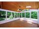 Bright sunroom featuring wood ceiling, skylight, fan, and walls of windows for natural light and scenic views at 3546 Weddington Oaks Dr, Weddington, NC 28104