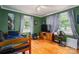Bright bedroom featuring green walls, wood flooring, and natural light from windows at 400 Houser St, Cherryville, NC 28021