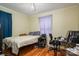 Standard bedroom showcasing wood floors with purple curtains and a ceiling fan at 400 Houser St, Cherryville, NC 28021