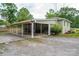 Home exterior featuring a convenient covered carport and lush surrounding greenery at 400 Houser St, Cherryville, NC 28021