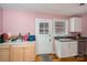 Kitchen shows contrasting cabinet styles, blending natural wood with painted surfaces at 400 Houser St, Cherryville, NC 28021