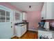 Compact kitchen features wood floors, light pink walls, and white cabinets at 400 Houser St, Cherryville, NC 28021