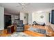 Open-concept living room with hardwood floors, ceiling fan and a bed in view at 400 Houser St, Cherryville, NC 28021