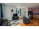 Cozy living room featuring wood floors, a ceiling fan, and lots of natural light at 400 Houser St, Cherryville, NC 28021