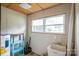 View of utility room featuring laundry sink and window. Ready for renovation at 400 Houser St, Cherryville, NC 28021