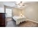 Neutral bedroom featuring a ceiling fan, dresser, and bright window at 4704 Amberside Dr, Rock Hill, SC 29732
