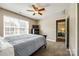 Comfortable bedroom with a ceiling fan, large window with blinds, and a TV on the dresser at 4704 Amberside Dr, Rock Hill, SC 29732