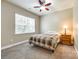 Cozy bedroom featuring a ceiling fan, a large window for natural light and carpeted floors at 4704 Amberside Dr, Rock Hill, SC 29732