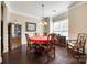 Formal dining room featuring hardwood floors, elegant wainscoting, and a red circular dining table at 4704 Amberside Dr, Rock Hill, SC 29732