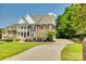 Beautiful two-story brick home featuring a double porch and manicured lawn at 4704 Amberside Dr, Rock Hill, SC 29732
