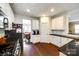 Well-lit kitchen boasts white cabinets, black countertops, and stainless steel appliances, adjacent dining area at 4704 Amberside Dr, Rock Hill, SC 29732