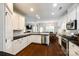Open kitchen features white cabinets, granite countertops, stainless steel appliances, and a view to living spaces at 4704 Amberside Dr, Rock Hill, SC 29732