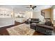 Spacious living room with hardwood floors, open floor plan, a large sectional sofa, and view to kitchen at 4704 Amberside Dr, Rock Hill, SC 29732