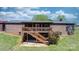 Brick home featuring a wooden deck with railings and stairs in the backyard at 4815 Rifle Range Rd, Conover, NC 28613