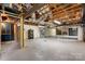 View of unfinished basement with exposed ducts and a brick fireplace, ready for customization and expansion at 4815 Rifle Range Rd, Conover, NC 28613