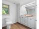 Bathroom features double sinks, ample cabinet space, toilet, and a window offering natural light at 4815 Rifle Range Rd, Conover, NC 28613