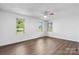 Neutral bedroom features a ceiling fan and three windows offering natural light at 4815 Rifle Range Rd, Conover, NC 28613