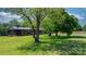 Ranch style home featuring a screened porch, brick facade, mature trees and a well-maintained lawn at 4815 Rifle Range Rd, Conover, NC 28613