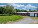 Charming ranch style home with brick facade, complemented by a gravel driveway and well-manicured lawn at 4815 Rifle Range Rd, Conover, NC 28613