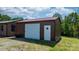 Metal garage featuring a red roof, white door, and pedestrian door, offering secure parking and storage at 4815 Rifle Range Rd, Conover, NC 28613