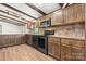 Well-equipped kitchen with stainless steel appliances, wood cabinets, and hardwood floors for culinary creativity at 4815 Rifle Range Rd, Conover, NC 28613