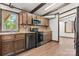 Modern kitchen with stainless steel appliances, wood cabinets, and hardwood floors provides a chef-friendly environment at 4815 Rifle Range Rd, Conover, NC 28613