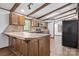 Cozy kitchen features tile countertops and backsplash, wood cabinets, and exposed beam ceiling at 4815 Rifle Range Rd, Conover, NC 28613