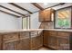 Cozy kitchen with wood cabinets, stone countertops, and hardwood floors is perfect for cooking and entertaining guests at 4815 Rifle Range Rd, Conover, NC 28613