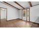 Bright living room features a walk-out glass door, and exposed beam ceiling at 4815 Rifle Range Rd, Conover, NC 28613