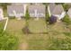 Aerial view of a well-maintained backyard with lush lawn, mature trees and surrounding houses at 5707 Parkstone Dr, Matthews, NC 28104