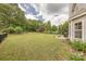 Picturesque backyard featuring a lush lawn, mature landscaping, and a patio with a grill for outdoor entertaining at 5707 Parkstone Dr, Matthews, NC 28104