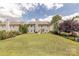 Spacious backyard with lush lawn, mature trees, and a charming fence, perfect for outdoor activities at 5707 Parkstone Dr, Matthews, NC 28104