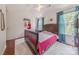 Bright bedroom with natural light, blue curtains, hardwood floors, and a cozy area rug at 5707 Parkstone Dr, Matthews, NC 28104