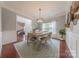 Elegant dining room with hardwood floors, a stylish light fixture, and natural light from the windows at 5707 Parkstone Dr, Matthews, NC 28104