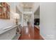 Spacious entryway featuring hardwood floors, a console table, and an open view of the staircase at 5707 Parkstone Dr, Matthews, NC 28104
