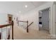 Hallway featuring carpet, wooden railings and trim at 5707 Parkstone Dr, Matthews, NC 28104