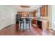 Open kitchen featuring wood cabinets, a center island with bar seating, and modern appliances at 5707 Parkstone Dr, Matthews, NC 28104