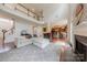 Open-concept living room with a fireplace, hardwood floors, and seamless access to the kitchen at 5707 Parkstone Dr, Matthews, NC 28104