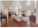 Bright living room with a fireplace, hardwood floors, vaulted ceilings, and large windows at 5707 Parkstone Dr, Matthews, NC 28104