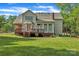 Charming back exterior featuring a well-manicured lawn and a cozy deck at 5775 Monticello Nw Dr, Concord, NC 28027