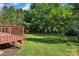 Expansive backyard with lush green lawn and a wooden deck at 5775 Monticello Nw Dr, Concord, NC 28027