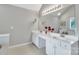 Bright bathroom featuring double sinks, a large mirror, and ample countertop space for convenience at 5775 Monticello Nw Dr, Concord, NC 28027