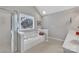 Relaxing bathroom with a large soaking tub, shower with glass door, and natural light from a window at 5775 Monticello Nw Dr, Concord, NC 28027