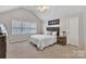 Bright bedroom with vaulted ceilings, a modern bed, and ample natural light from a large window at 5775 Monticello Nw Dr, Concord, NC 28027