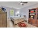 Cozy bedroom featuring a ceiling fan, area rug, and a built-in bookcase at 5775 Monticello Nw Dr, Concord, NC 28027