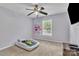 Cozy bedroom featuring a ceiling fan, bright window, and soft colors creating a relaxing environment at 5775 Monticello Nw Dr, Concord, NC 28027