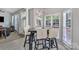 Bright breakfast nook is adorned with an elegant chandelier and surrounded by windows for natural light at 5775 Monticello Nw Dr, Concord, NC 28027