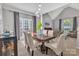 Light-filled dining room boasts high ceilings, pendant lighting, and a stylish table for elegant meals at 5775 Monticello Nw Dr, Concord, NC 28027