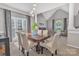 Elegant dining area featuring a large window, modern light fixture, and open living space at 5775 Monticello Nw Dr, Concord, NC 28027